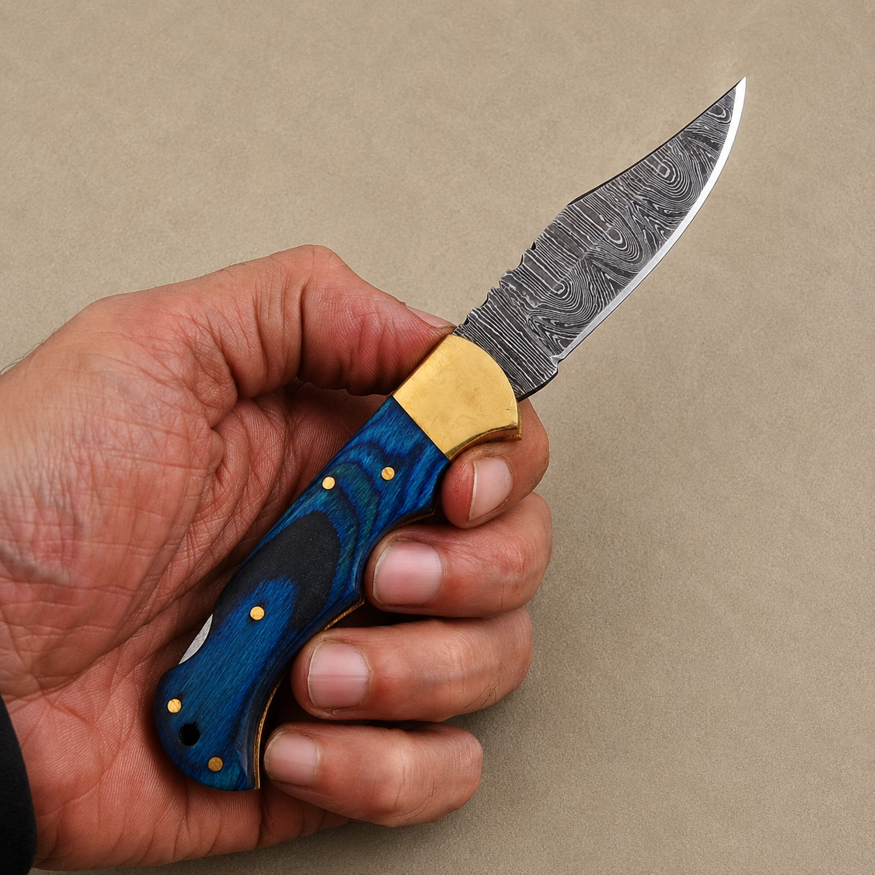 Cobalt Crest Damascus Folding Knife – Hand Forged Steel with Blue Pakka Wood Handle, Brass Bolster & Leather Sheath