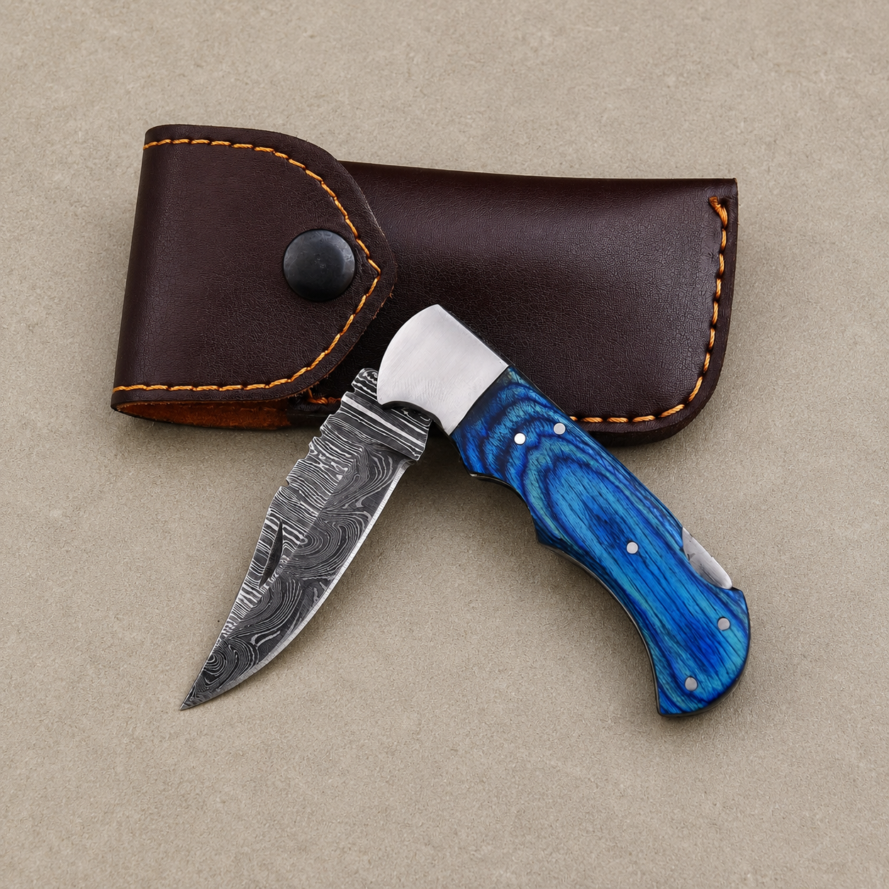 Personalized Damascus Folding Knife – Blue Pakka Wood Handle, Steel Bolster, Back Lock & Leather Sheath | Custom Engraved Gift