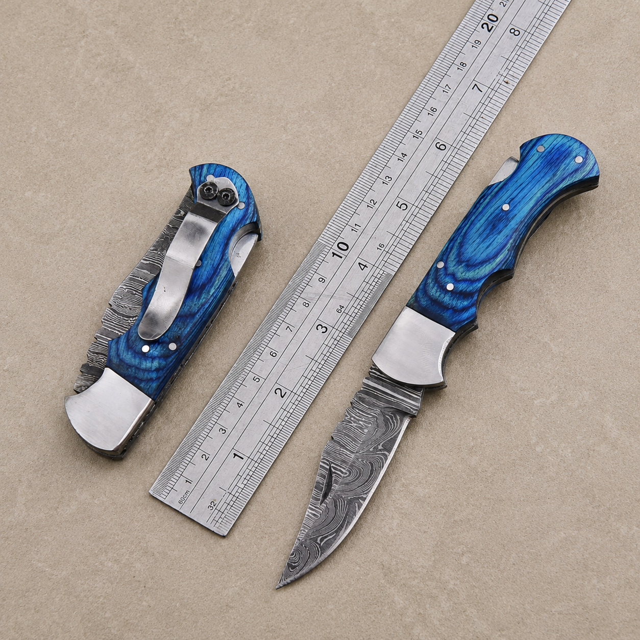 Personalized Damascus Folding Knife – Blue Pakka Wood Handle, Steel Bolster, Back Lock & Leather Sheath | Custom Engraved Gift