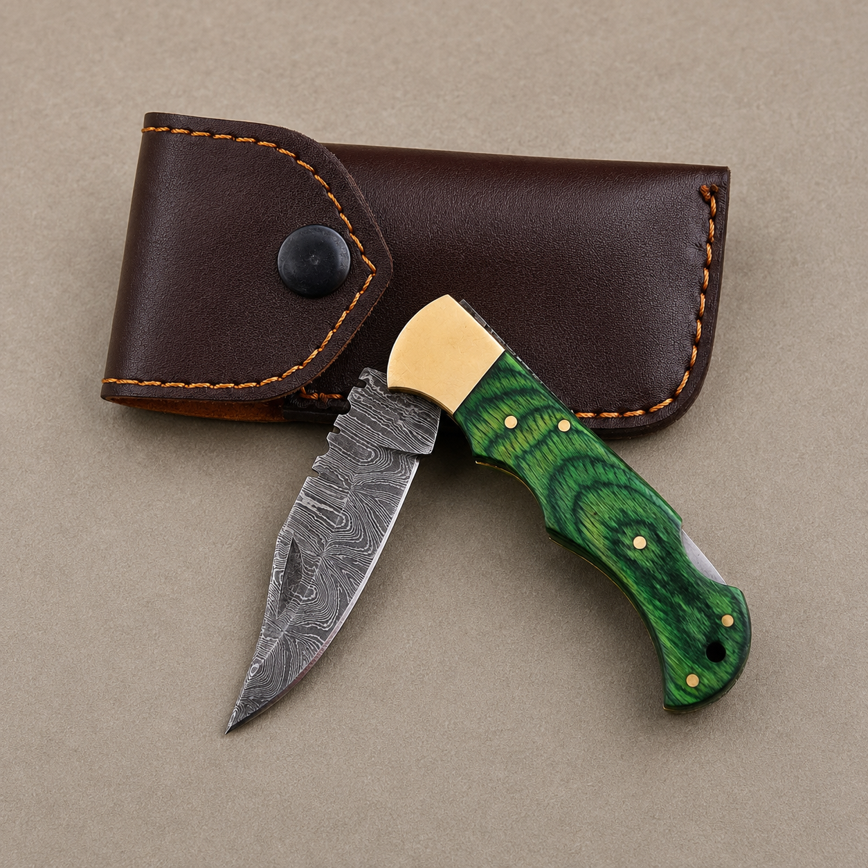 Emerald Ridge Damascus Folding Knife – Hand Forged Steel with Green Pakka Wood Handle, Brass Bolster & Leather Sheath