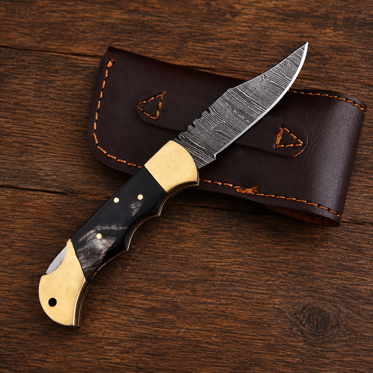 Heritage Damascus Folding Knife – Black Bull Horn Handle, Brass Bolster & Leather Sheath