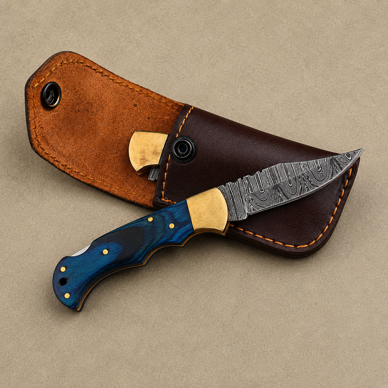 Cobalt Crest Damascus Folding Knife – Hand Forged Steel with Blue Pakka Wood Handle, Brass Bolster & Leather Sheath