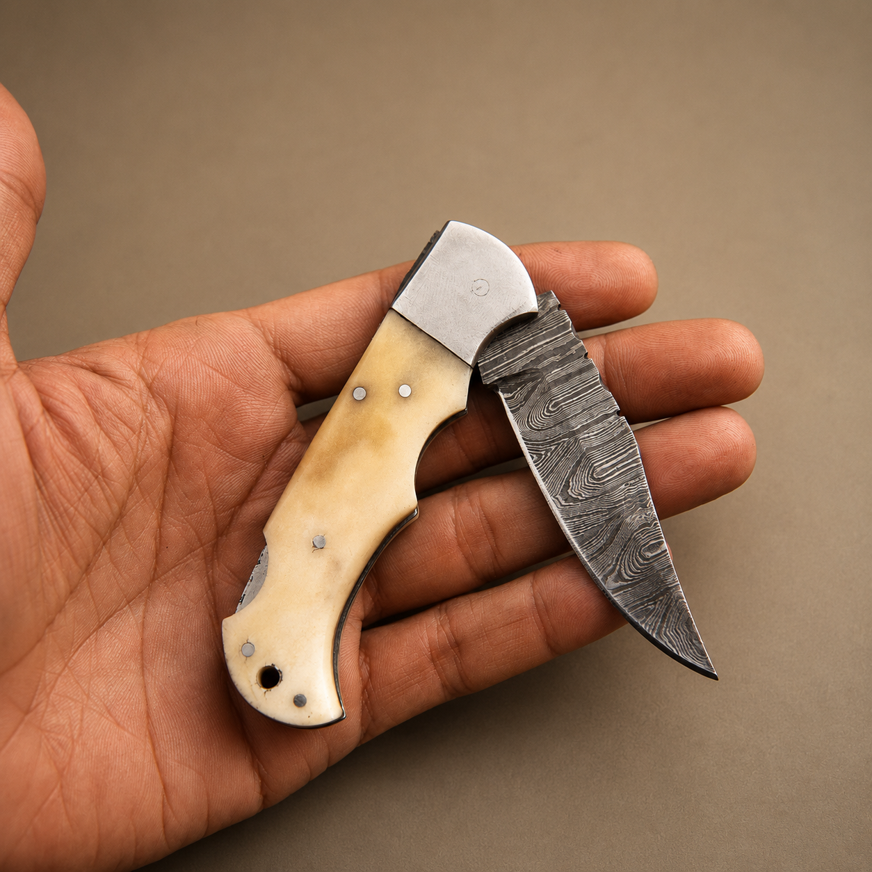 Ivory Peak Damascus Folding Knife – Premium Ivory Horn Handle, Steel Bolster & Leather Sheath