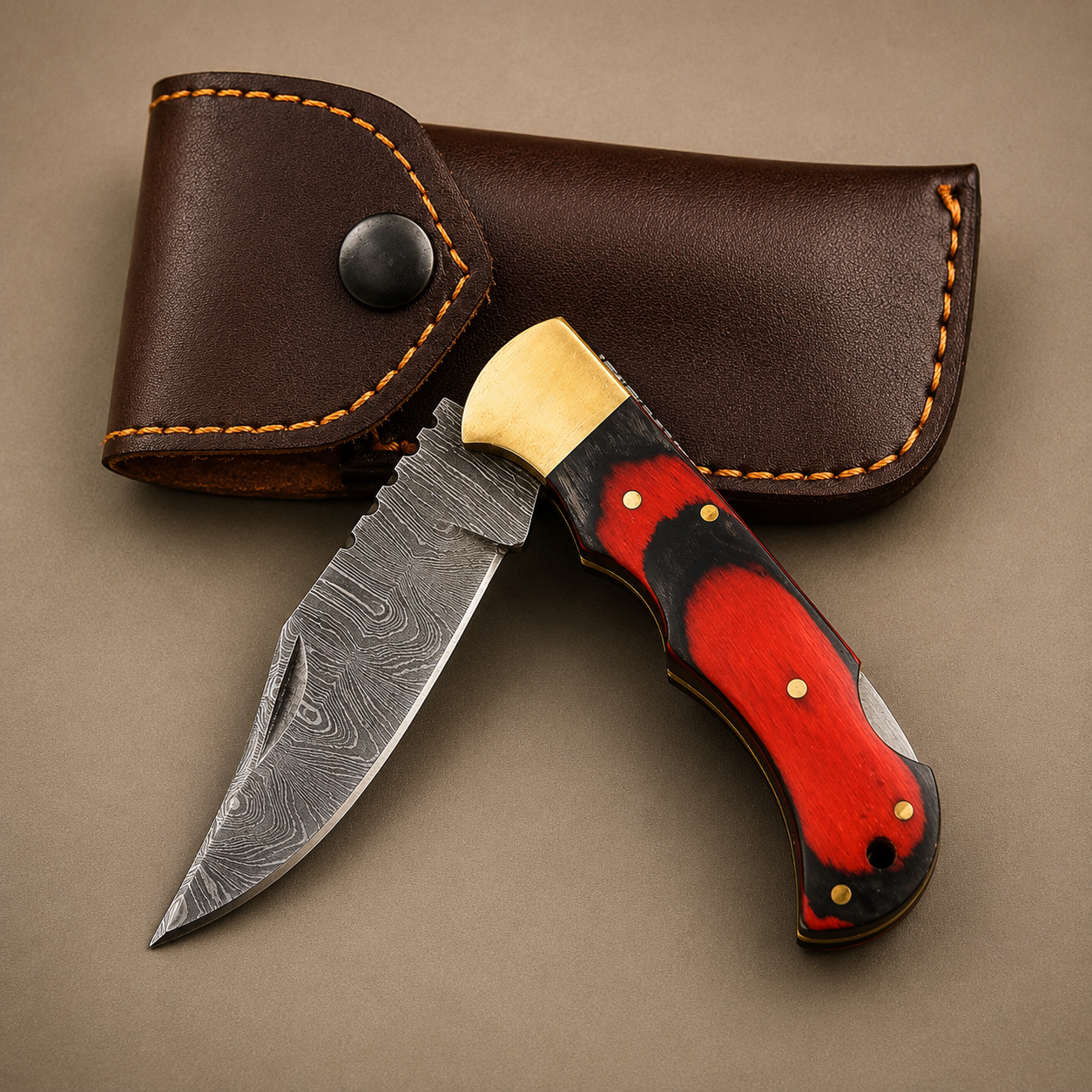 Crimson Oak Damascus Folding Knife – Red & Black Pakka Wood Handle, Brass Bolster & Leather Sheath