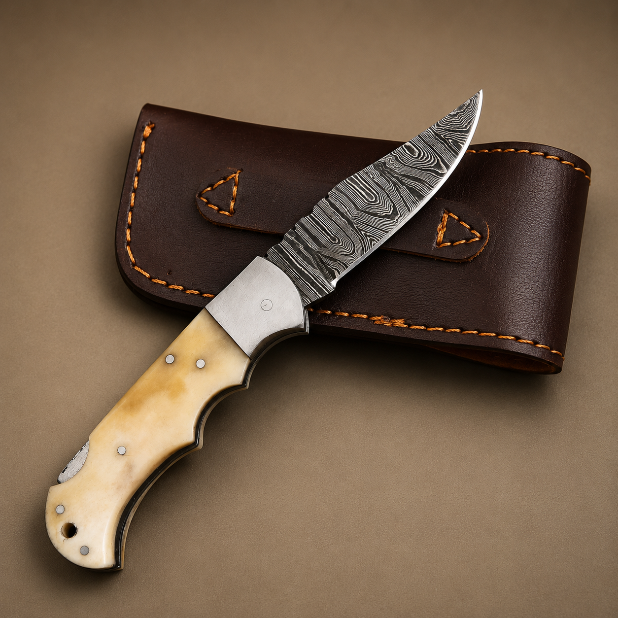 Ivory Peak Damascus Folding Knife – Premium Ivory Horn Handle, Steel Bolster & Leather Sheath